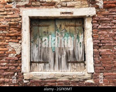 closed window blinds of an old brick house Stock Photo