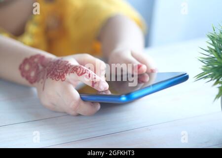 child girl using smart phone on table  Stock Photo