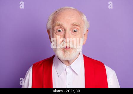 Photo of positive old funky man make funny face good mood wear red vest isolated on violet color background Stock Photo