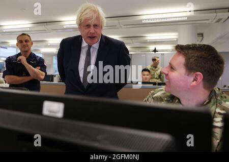 Prime Minister Boris Johnson observes the operations room for the Afghan Relocation and Assistance Policy during a visit to Northwood Headquarters, the British Armed Forces Permanent Joint Headquarters, in Eastbury, north west London, where he met with personnel working on the UK operation in Afghanistan. Picture date: Thursday August 26, 2021. Stock Photo