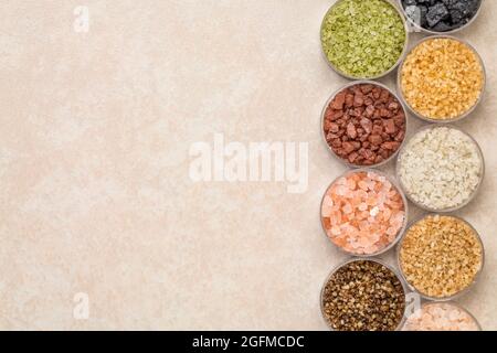 collection of colorful sea salts from different parts of the world, top view on a ceramic background with a copy space Stock Photo