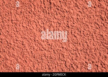 Pink wall, texture, background. Relief surface. Plastered building wall, painted with water-based pink paint. Decorated red or pink surface Stock Photo