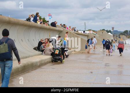Dymchurch, Kent, UK. 26 Aug, 2021. UK Weather: Overcast and windy in the seaside town of Dymchurch in Kent as brits on staycation enjoy splashing about in the sea. Photo Credit: Paul Lawrenson/ Alamy Live News Stock Photo