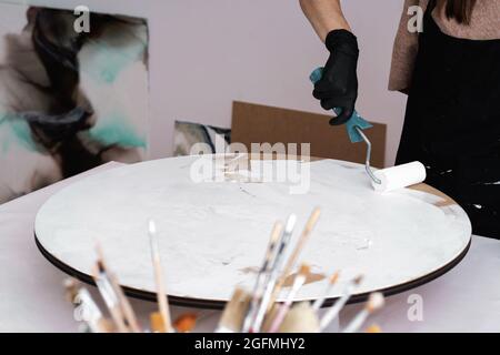 Young artist paints in the home office. Stock Photo