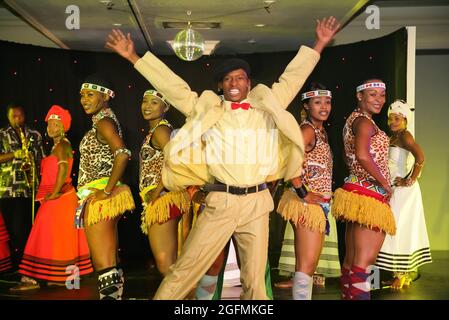JOHANNESBURG, SOUTH AFRICA - May 03, 2019: traditional African dancers with Zulu wear and blue lights Stock Photo
