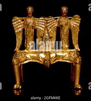 Standard for an altar cross in the shape of two angels on a pedestal   1170 brazier (anonymous)  Mosan, Maastricht Dutch, The Netherlands . bronze,metal,ring,iron, casting, engraving, gilding, drilling angels, ornaments, hybrid ,animals,  ornament , hybrid ,animals, Stock Photo