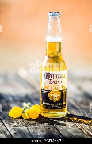 Corona bottle at the beach with lime fruit ready to drink. Corona Extra is produced in Mexico and exported to all other countries all over the world. Stock Photo