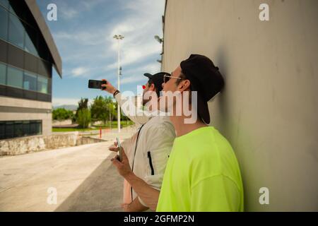 Two male friends are talking selfie whiel hanging out together Stock Photo