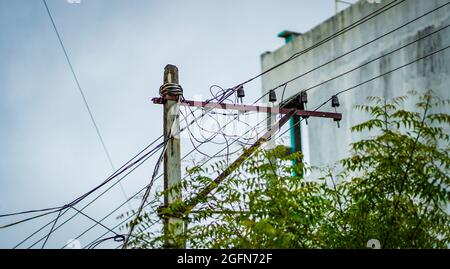 Closeup of the messy wires on a transmission pole outdoors Stock Photo