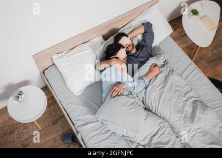 gay couple in eye masks sleeping in bed Stock Photo - Alamy