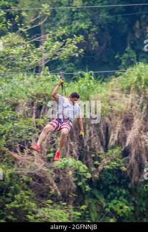 PULHAPANZAK, HONDURAS - APRIL 18, 2016: Tourist is canopying over Pulhapanzak waterfall Stock Photo