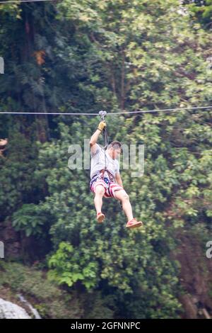 PULHAPANZAK, HONDURAS - APRIL 18, 2016: Tourist is canopying over Pulhapanzak waterfall Stock Photo