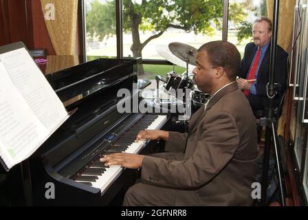 SAINT LOUIS, UNITED STATES - Jul 02, 2009: An African-American male playing the piano accompanied by a drummer Stock Photo