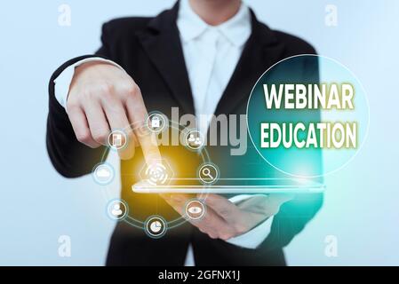 Text sign showing Webinar Education. Business idea online meeting or presentation held via the Internet Lady In Suit Pointing On Tablet Showing Stock Photo