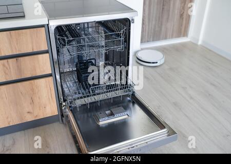 modern Half open empty dishwasher in a modern kitchen Stock Photo