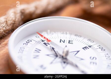 Compass and rope on a close-up. Compass arrow close up. Stock Photo