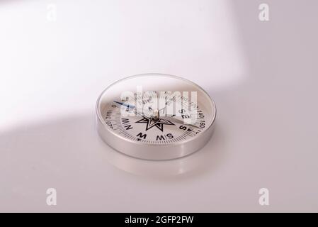 Compass on a white background. Sun glare compass. Stock Photo