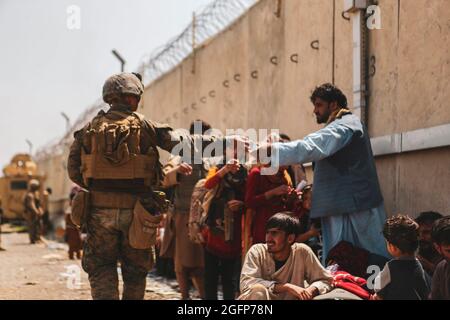 210822-M-TU241-1007 HAMID KARZAI INTERNATIONAL AIRPORT, Afghanistan (August 22, 2021 via Sipa USA) A Marine with the 24th Marine Expeditionary unit (MEU via Sipa USA) passes out water to evacuees during an evacuation at Hamid Karzai International Airport, Kabul, Afghanistan, Aug. 22. U.S. service members are assisting the Department of State with a Non-combatant Evacuation Operation (NEO via Sipa USA) in Afghanistan. (U.S. Marine Corps photo by Sgt. Isaiah Campbell via Sipa USA) Please note: Fees charged by the agency are for the agency’s services only, and do not, nor are they intended to, co