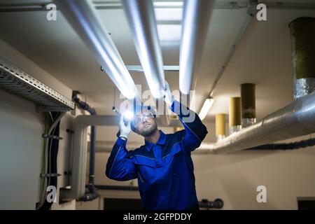 PVC Water Pipe Inspection By Construction Worker Stock Photo