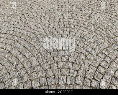 Granite paving stones on the sidewalk, textured paving background. Stock Photo