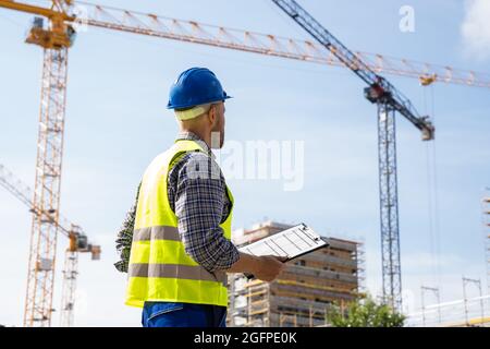 OSHA Inspector At Construction Site. Young Engineer Worker Stock Photo