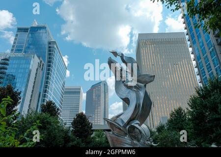 Charlotte, North Carolina, USA - August 24, 2021: Modern sculpture framed by city skyline at Romare Bearden Park Stock Photo