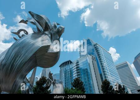 Charlotte, North Carolina, USA - August 24, 2021: Modern sculpture framed by city office towers from Romare Bearden Park Stock Photo