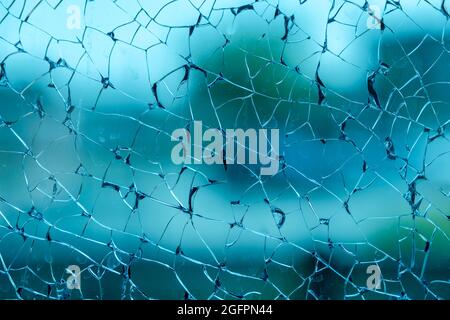 Shattered safety glass with blue, purple and teal hues Stock Photo