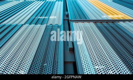 Teal and yellow metal building exterior abstract in Charlotte, North Carolina, USA Stock Photo