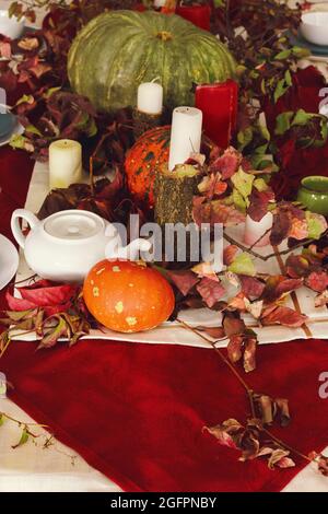 Stylish thanksgiving autumn table decor with pumpkin and dried branches Stock Photo