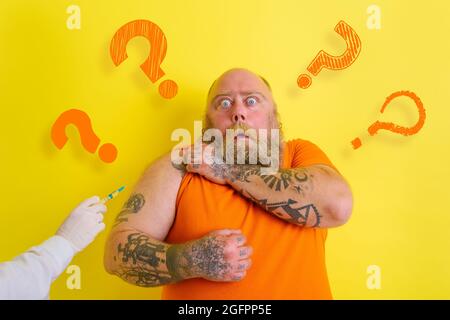 Fat doubter man has doubts about covid-19 vaccine Stock Photo