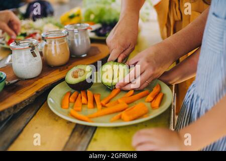 image of hands cutting an avocado Stock Photo