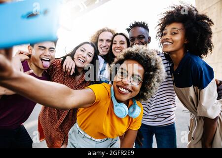 Diverse friends taking selfie together Stock Photo