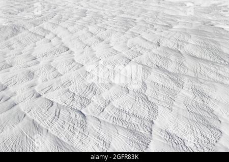 Textured effect of waves on surface of gray-white stone. Pamukkale travertine surface in Turkey. Stock Photo