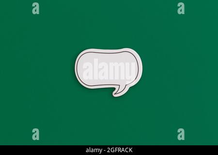 Paper speech bubble on a yellow background. Top view with copy space. Flat lay. Stock Photo