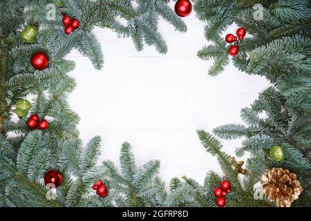 Creative frame made of Christmas fir branches on white background Stock Photo