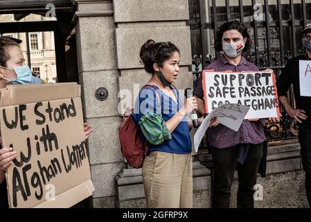 Protesters hold placards during the demonstration.Dozens of people gathered in front of Ireland's parliament building, Leinster House, to demand that the Irish government welcomes more Afghan refugees. United Against Racism organized the protest, while other parties and organizations such as People Before Profit, ROSA, and Le Chéile were also present. Protesters argued that since the Irish government had previously allowed the US military to use Shannon Airport, Ireland should no longer refuse to accept refugees. (Photo by Natalia Campos/SOPA Images/Sipa USA) Stock Photo