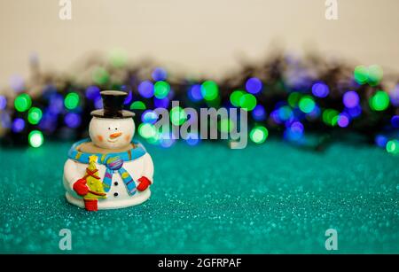 Christmas lights and snowman over abstract lights. Merry christmas Stock Photo