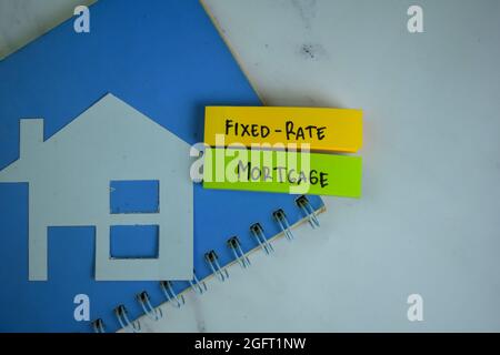 Fixed-Rate Mortgage write on sticky notes isolated on Wooden Table. Stock Photo