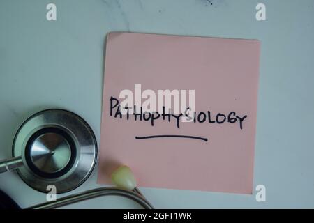 Pathophysiology write on sticky notes isolated on Wooden Table. Stock Photo