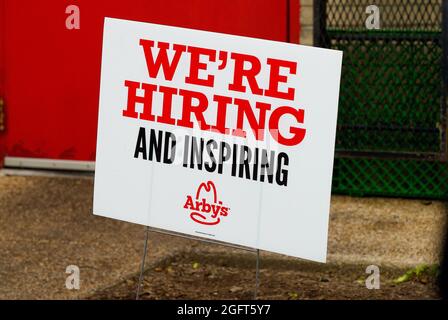 Chantilly, Virginia, USA - May 27, 2021: Close-up image of a sign posted outside an Arby's Restaurant drive-through advertising 'We're Hiring'. Stock Photo