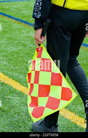 Annandale, Virginia / USA - April 24, 2021: Close-up image of a soccer sideline judge's colorful flag. Stock Photo