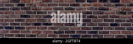 Panoramic background of wide old dark red brick wall texture. brown panoramic background Stock Photo