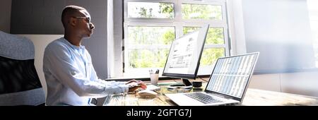African American Tax Accountant Checking Invoice On Office Computer Stock Photo