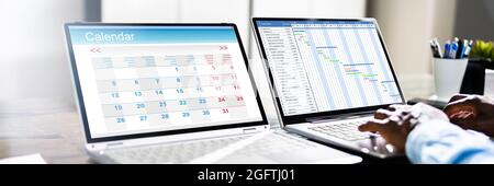 Gantt Chart Calendar Schedule On Multiple Laptop Computers Stock Photo