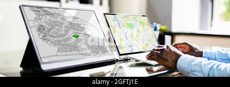 Close-up Of A Businessperson Analyzing Cadastre Map On Computer In The Office Stock Photo