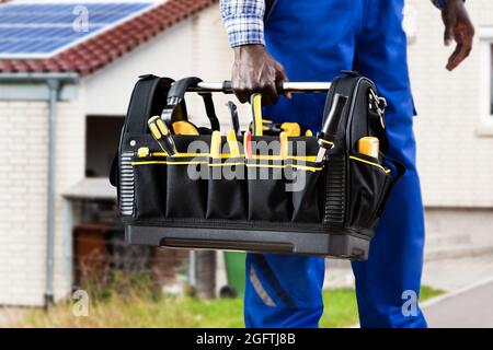 African American Handyman With Repair Box Or Toolbox Stock Photo