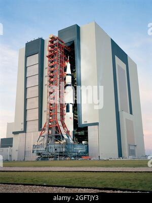 (9 Nov. 1970) --- A ground level view at Launch Complex 39, Kennedy Space Center (KSC), showing the Apollo 14 (Spacecraft 110/Lunar Module 8/Saturn 509) space vehicle leaving the Vehicle Assembly Building (VAB). The Saturn V stack and its mobile launch tower, atop a huge crawler-transporter, were rolled out to Pad A. The Apollo 14 crewmen will be astronauts Alan B. Shepard Jr., commander; Stuart A. Roosa, command module pilot; and Edgar D. Mitchell, lunar module pilot Stock Photo