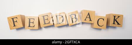 The word FEEDBACK was created from wooden cubes. shopping and communication. Close-up. Stock Photo