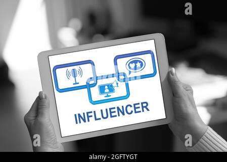 Influencer concept shown on a tablet held by a woman Stock Photo
